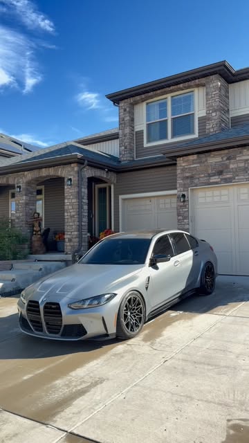 White BMW freshly detailed in a Denver driveway