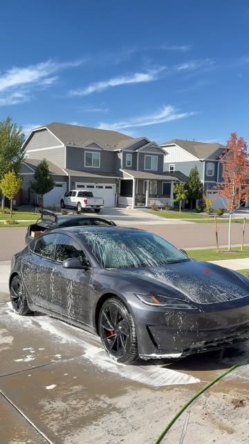Black Tesla during a foam wash